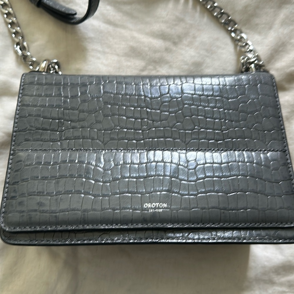 Meghan Markle worn brand Oroton crossbody bag.